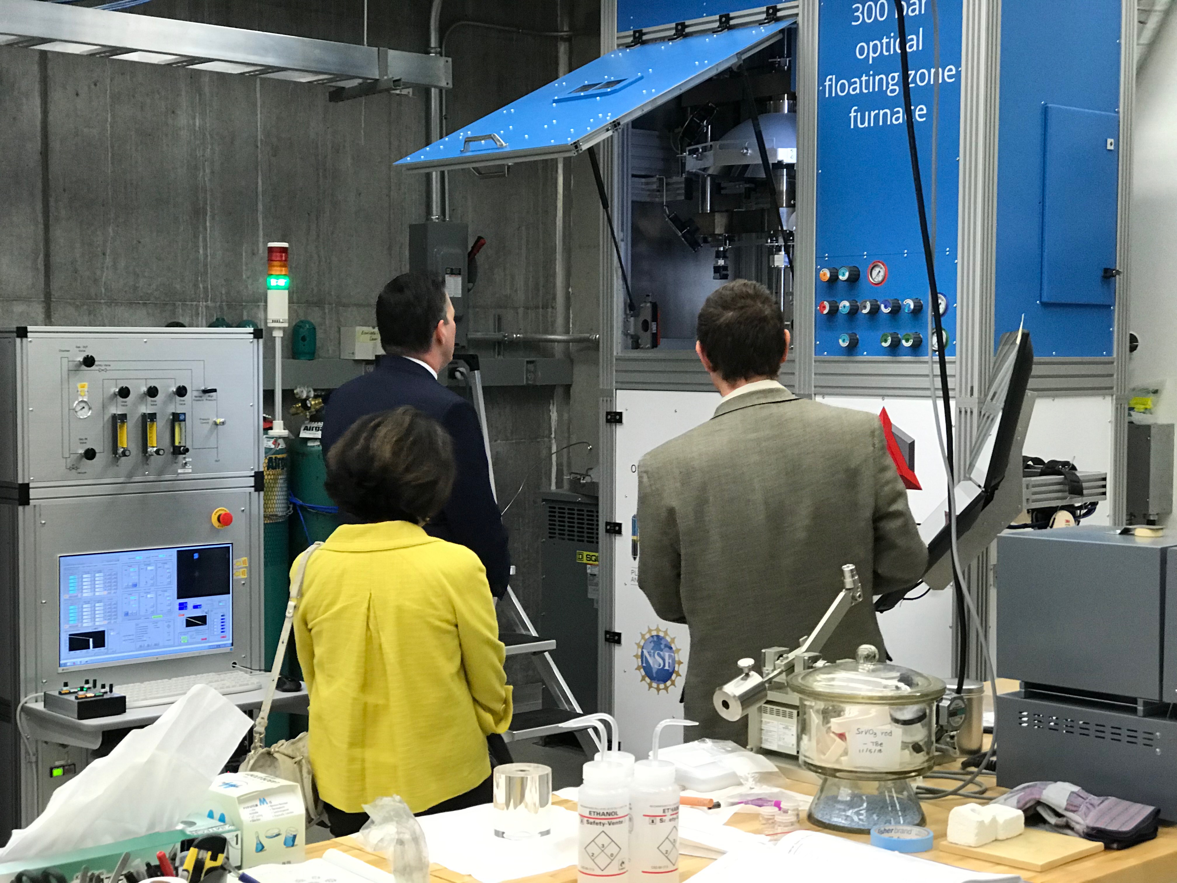 Officials viewing lab equipment